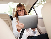 lady reading in back of car